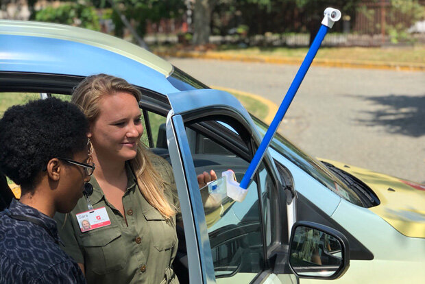 Two volunteers attached a temperature sensor to a car