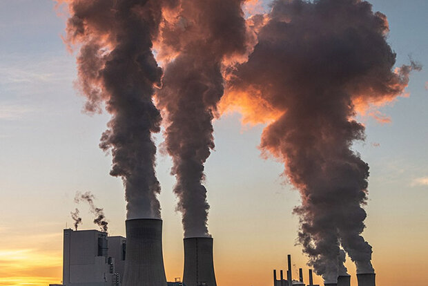 Smokestacks in low-angled sunlight