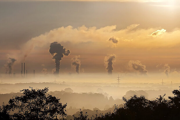 Smokestacks above fog