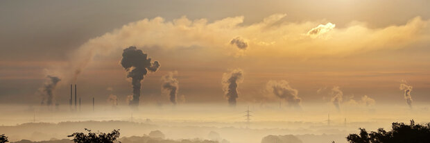A sunrise behind a factory