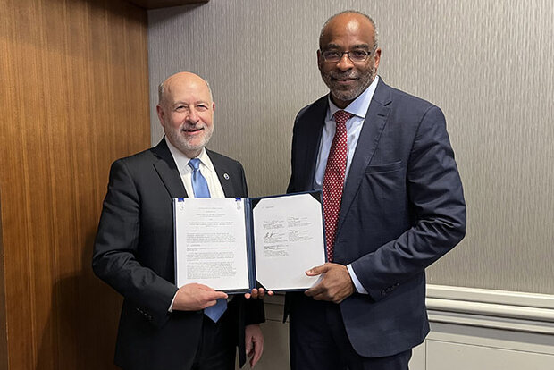 NOAA and NCAR leaders holding memorandum
